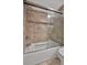 Updated bathroom with a bathtub and sliding glass shower door at 5800 Hollywood Blvd # 115, Sarasota, FL 34231