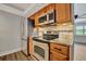 Updated kitchen with wood cabinets and stainless steel appliances at 5800 Hollywood Blvd # 115, Sarasota, FL 34231