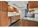 Updated kitchen with wood cabinets, granite counters, and stainless steel appliances at 5800 Hollywood Blvd # 115, Sarasota, FL 34231