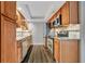 Updated kitchen with wood cabinets, granite counters, and stainless steel appliances at 5800 Hollywood Blvd # 115, Sarasota, FL 34231