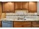 Modern kitchen sink and granite countertop with wood cabinets at 5800 Hollywood Blvd # 115, Sarasota, FL 34231