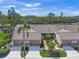 Aerial view showing two villas with attached garages and well-manicured gardens at 5958 Clubside Dr, Sarasota, FL 34243