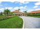 Driveway and entrance to Palm Aire Country Club's clubhouse, featuring landscaping at 5958 Clubside Dr, Sarasota, FL 34243