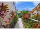 Private courtyard with brick walkways, lush tropical plants, and a relaxing seating area at 5958 Clubside Dr, Sarasota, FL 34243
