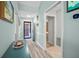 Light and airy entryway with wood-look floors and access to other rooms at 5958 Clubside Dr, Sarasota, FL 34243
