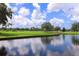 Golf course with water features and lush vegetation, reflecting clouds in the water at 5958 Clubside Dr, Sarasota, FL 34243