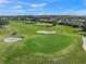 Golf course with green, sand traps, and golf cart at 5958 Clubside Dr, Sarasota, FL 34243