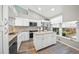 Modern kitchen with white cabinetry, granite countertops, and an island at 5958 Clubside Dr, Sarasota, FL 34243