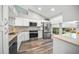Updated kitchen features granite countertops, stainless steel appliances, and white cabinets at 5958 Clubside Dr, Sarasota, FL 34243
