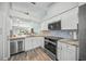 Modern kitchen with white cabinets, granite countertops, and stainless steel appliances at 5958 Clubside Dr, Sarasota, FL 34243