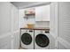 Laundry room with washer, dryer, and extra storage at 5958 Clubside Dr, Sarasota, FL 34243