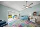 Bright living room with hardwood floors, ceiling fan, and access to patio at 5958 Clubside Dr, Sarasota, FL 34243