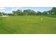 Landscaped putting green with flags providing a space for golf practice at 5958 Clubside Dr, Sarasota, FL 34243
