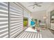 Sunroom with tiled floor, ceiling fan, and relaxing seating at 5958 Clubside Dr, Sarasota, FL 34243