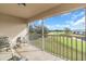 Screened balcony overlooks golf course with seating for relaxing at 6507 Stone River Rd # 306, Bradenton, FL 34203