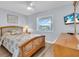 Comfortable bedroom with wood bed and flat screen TV at 6507 Stone River Rd # 306, Bradenton, FL 34203