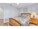 Cozy bedroom with wood frame bed and window at 6507 Stone River Rd # 306, Bradenton, FL 34203