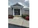 Community building with double doors and landscaping at 6507 Stone River Rd # 306, Bradenton, FL 34203