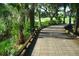 Wooden path winding through lush golf course at 6507 Stone River Rd # 306, Bradenton, FL 34203