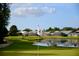 Scenic golf course view with lake and houses at 6507 Stone River Rd # 306, Bradenton, FL 34203