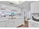 Condo kitchen with white cabinets and appliances at 6507 Stone River Rd # 306, Bradenton, FL 34203