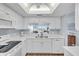 Condo kitchen with white cabinets, double sink, and view at 6507 Stone River Rd # 306, Bradenton, FL 34203
