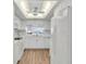 Condo kitchen with white cabinets and breakfast bar at 6507 Stone River Rd # 306, Bradenton, FL 34203