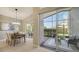 Open dining area adjacent to the lanai, featuring modern lighting and neutral decor at 6510 42Nd E St, Sarasota, FL 34243