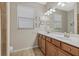 Elegant bathroom with double vanity and large mirror at 6519 Rosehill Farm Run, Bradenton, FL 34211