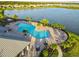 Resort-style pool with lounge chairs and a lake view at 6519 Rosehill Farm Run, Bradenton, FL 34211