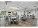 Community room with tables, chairs, a fireplace, and a bar at 6519 Rosehill Farm Run, Bradenton, FL 34211