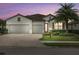 Beautiful two-story home with a three-car garage and lush landscaping at 6519 Rosehill Farm Run, Bradenton, FL 34211