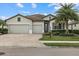 Two-car garage, light gray exterior, and a nicely landscaped front yard at 6519 Rosehill Farm Run, Bradenton, FL 34211