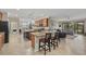 Open kitchen with granite countertops, island, and stainless steel appliances at 6519 Rosehill Farm Run, Bradenton, FL 34211