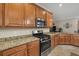 Kitchen with granite countertops and stainless steel appliances at 6519 Rosehill Farm Run, Bradenton, FL 34211