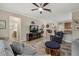 Open living room with a view into the kitchen and a cozy fireplace at 6519 Rosehill Farm Run, Bradenton, FL 34211