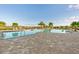 Community pool with a large patio and lounge chairs at 6519 Rosehill Farm Run, Bradenton, FL 34211