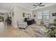 Bright sitting room with two armchairs, a wooden secretary, and a ceiling fan at 6519 Rosehill Farm Run, Bradenton, FL 34211