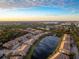 Aerial view of community near lake at sunset at 7022 Prosperity Cir # 801, Sarasota, FL 34238