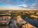 Aerial view of community by a lake and road at 7022 Prosperity Cir # 801, Sarasota, FL 34238