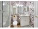 Tropical-themed bathroom with toucan wallpaper, white vanity, and walk-in shower at 7022 Prosperity Cir # 801, Sarasota, FL 34238