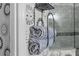 Close-up of a neatly organized bathroom with rolled towels and a metal shelf at 7022 Prosperity Cir # 801, Sarasota, FL 34238