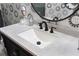 Bathroom vanity with unique speckled countertop and black fixtures at 7022 Prosperity Cir # 801, Sarasota, FL 34238