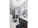 Modern bathroom with a walk-in shower, unique wallpaper and floating vanity at 7022 Prosperity Cir # 801, Sarasota, FL 34238