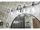Stylish bathroom light fixture with clear glass globes and modern black finish at 7022 Prosperity Cir # 801, Sarasota, FL 34238