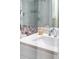 White bathroom vanity with vessel sink and wicker soap dispenser at 7022 Prosperity Cir # 801, Sarasota, FL 34238
