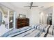 Guest bedroom with two twin beds, balcony access, and dresser at 7022 Prosperity Cir # 801, Sarasota, FL 34238