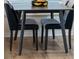 Small dining area with dark wood table and four black chairs at 7022 Prosperity Cir # 801, Sarasota, FL 34238