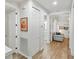 Bright hallway with light wood flooring, white walls, and doors leading to rooms at 7022 Prosperity Cir # 801, Sarasota, FL 34238