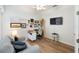 Bright home office with desk, seating, and large TV at 7022 Prosperity Cir # 801, Sarasota, FL 34238